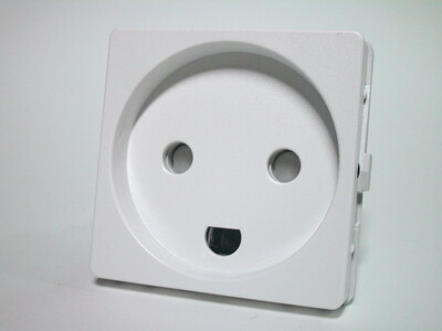 Front view of the Danish power socket. The socket has two holes for the line and neutral pins, protected by shutters, and a semi-circular hole for the earth. A small recess is present.