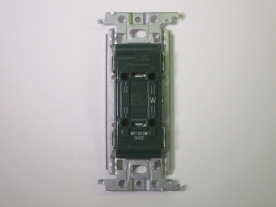 Rear of the socket, view of the terminals which are housed in a green plastic body.